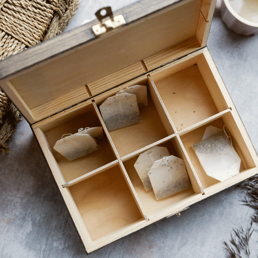 a wooden box with tea bags inside