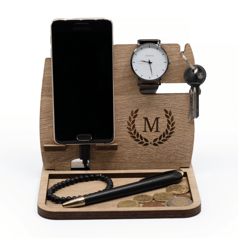 a phone and watch on a wooden stand