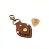 a brown leather guitar pick holder key chain with a personalised wooden pick