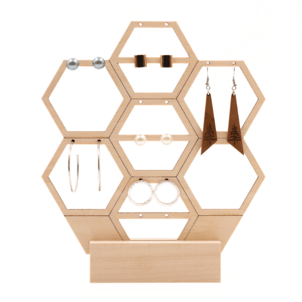 a wooden honeycomb jevelery stand