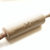a personalised wooden rolling pin with a logo on it