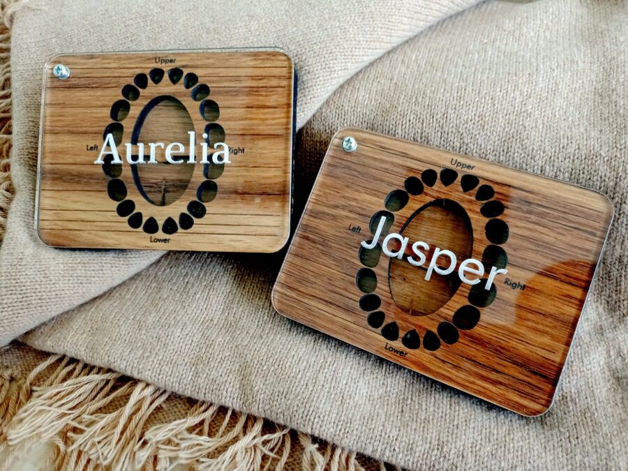 a wooden baby tooth box with a glass lid