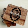 a wooden baby tooth box with a glass lid