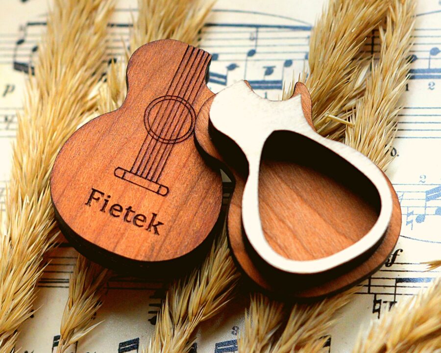 a wooden guitar shaped pick box