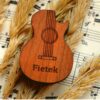 a wooden guitar shaped pick box
