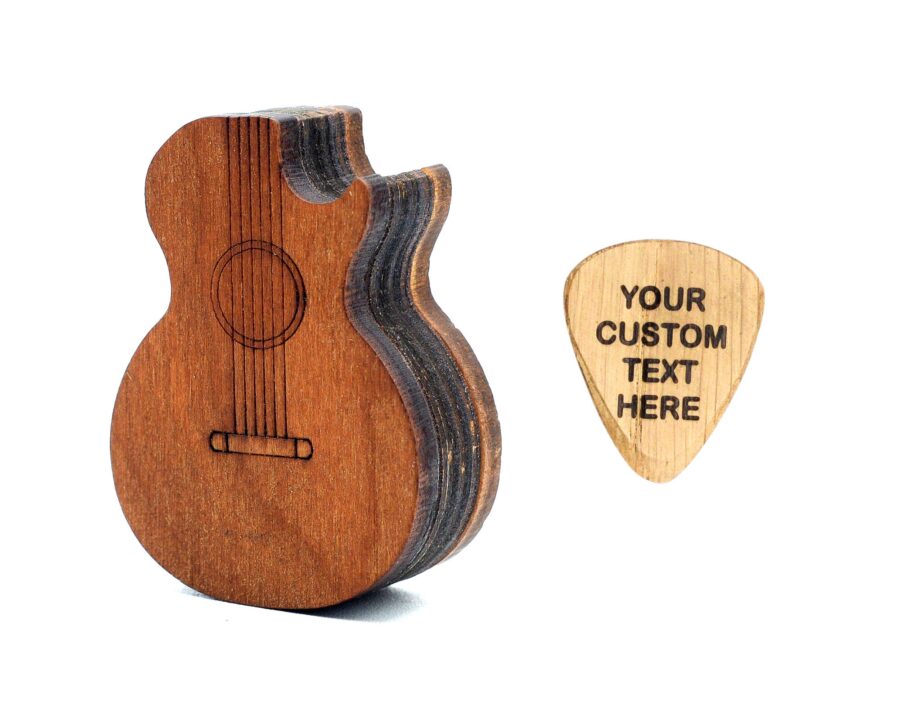 a wooden guitar shaped pick box with engraved pick